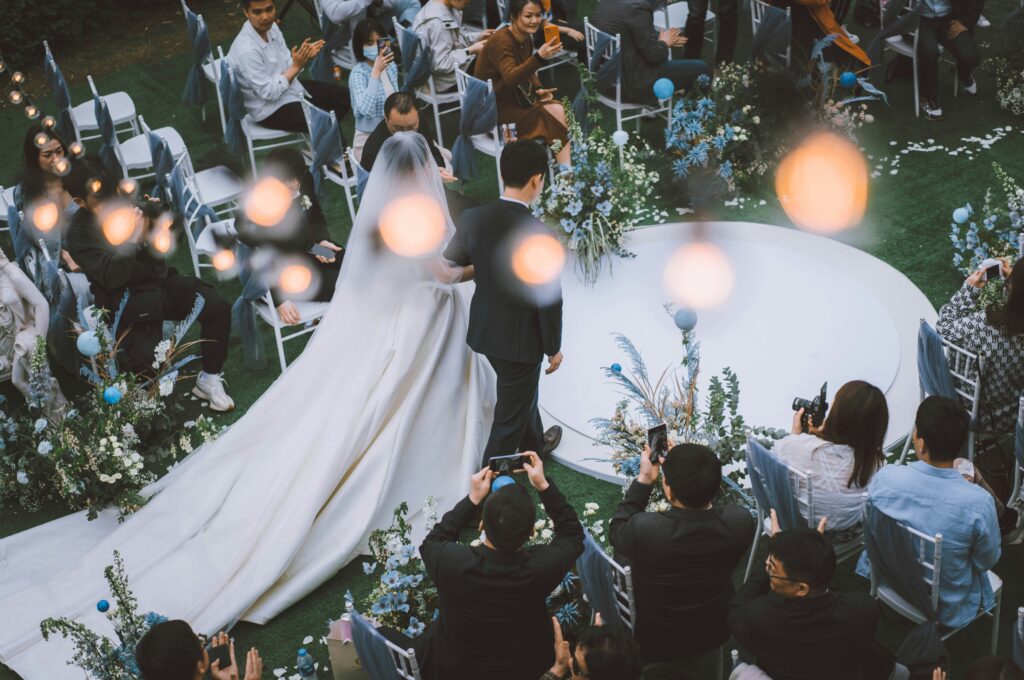 Couple’s first dance under twinkling fairy lights at evening wedding.